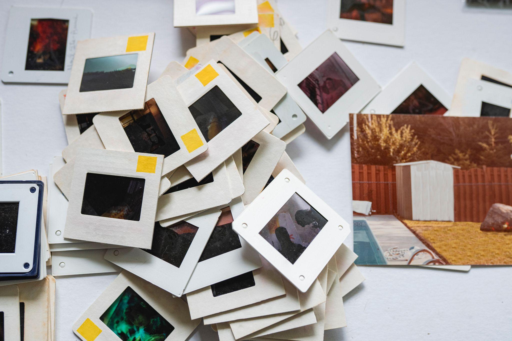 Pile of vintage photo slides and print.