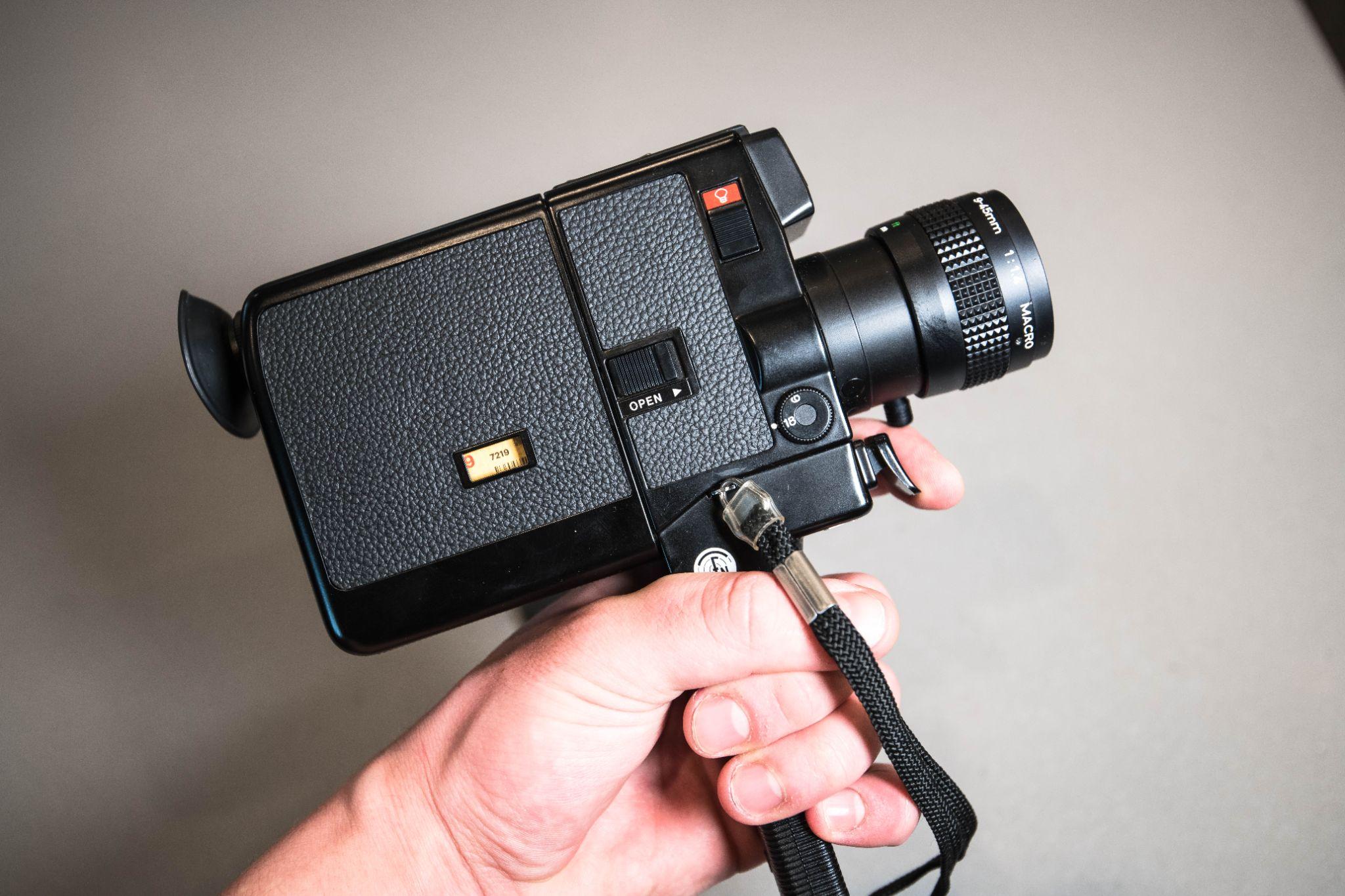 Hand holding vintage film camera