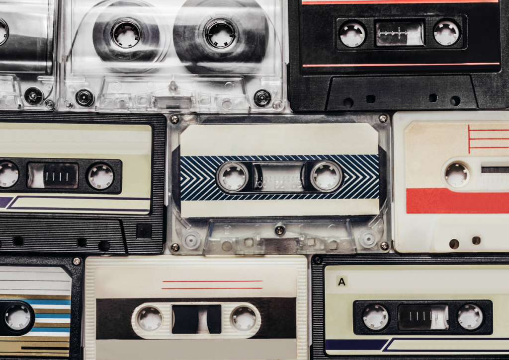 Vintage cassette tapes stacked together, close-up view.