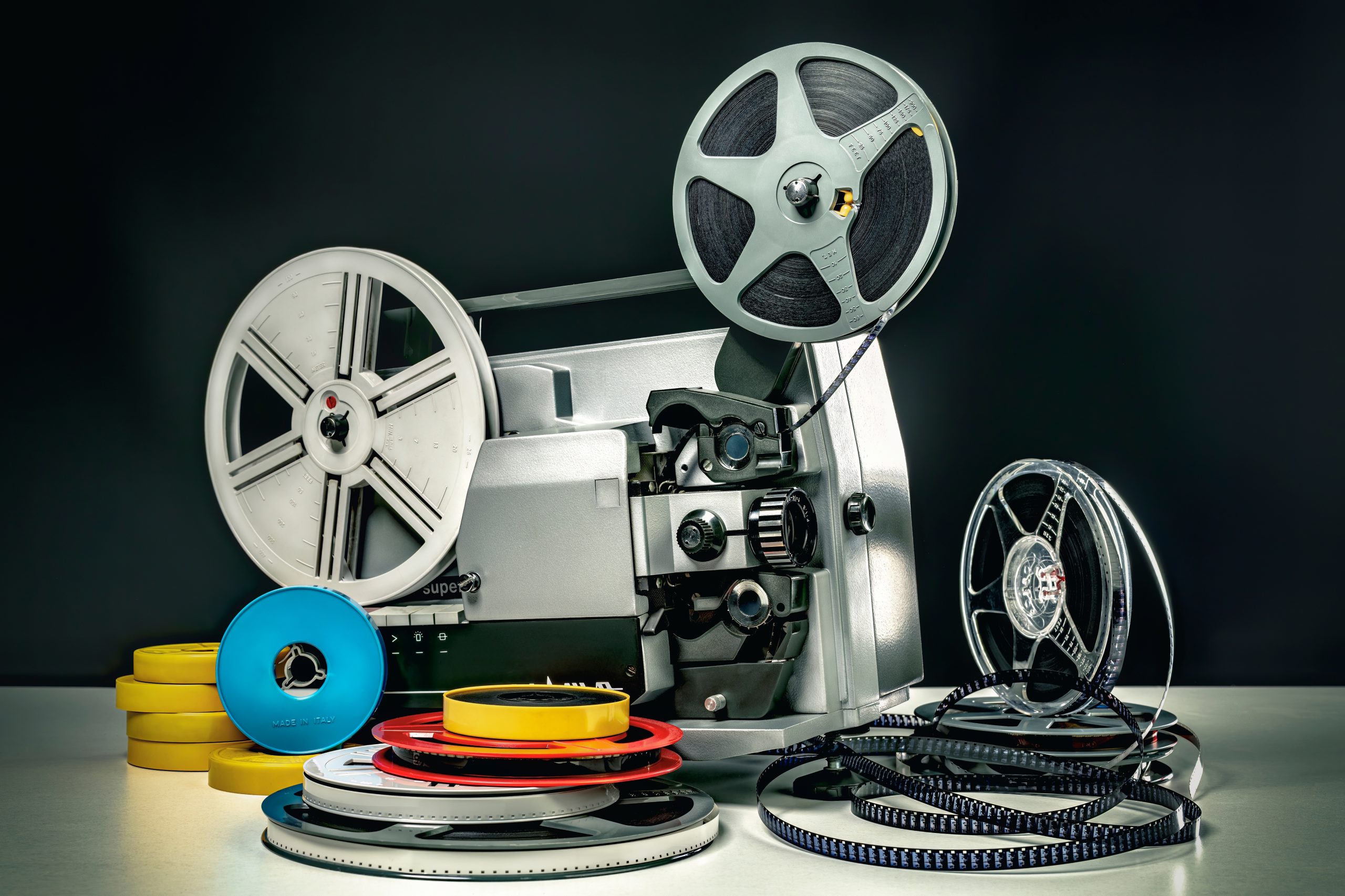 Vintage film projector with reels on display.